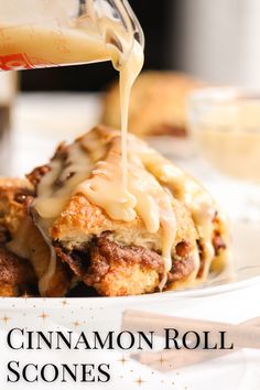 someone is pouring sauce on top of some food that is on a plate with cinnamon sticks