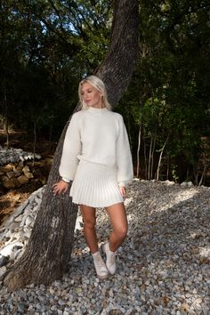 DESCRIPTION: The Vanilla Bean Pleated Knit Mini Skirt the epitome of cozy chic. This skirt features soft knit fabric in a classic cream shade, combining comfort and style seamlessly. Pair with the matching sweater and layer for colder days! DETAILS: Mini length Pleated True to size Shane is 5'10" with a 27" waist + 32B bust and is wearing a small. FABRIC: 42% Nylon, 40% Acrylic, 12% polyester, 6% wool Knitted Mini Skirt Outfit, White Skirt Outfit Fall, White Skirt Winter, White Pleated Skirt Outfit, Pleated Mini Skirt Outfit, Skirt Outfit Fall, Brown Tights, White Skirt Outfits, Pleated Skirt Outfit