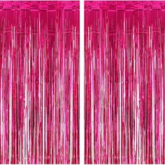 two pink curtains with fringes hanging from the top and bottom, one in red