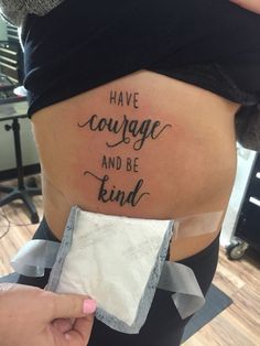 a woman's stomach with the words have courage and be kind written on it