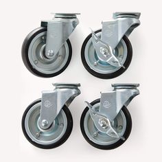 four metal casteors with black rubber wheels