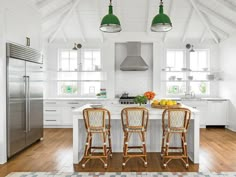 two stools sit at the center of a kitchen island