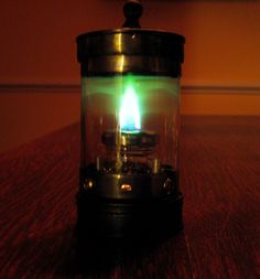 a green light in a glass container on a table