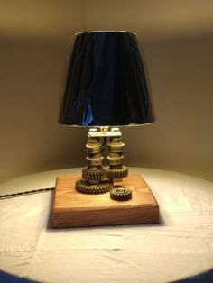 a lamp that is sitting on top of a table next to a light bulb and some coins