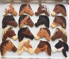 decorated cookies in the shape of horses on a tray