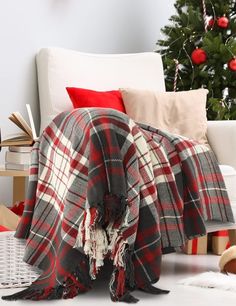 a christmas tree is in the background with red and white plaid blankets