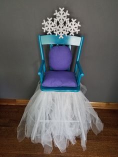 a chair with a snowflake on it and a purple pillow in the back