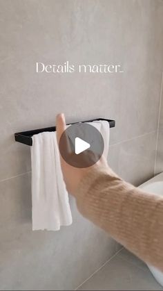 a person is holding a towel rack in their hand and pointing at it with the word details matter