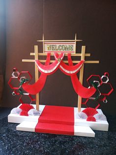 a red carpeted stage set up for a welcome sign