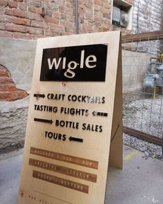 a sign that says wigle craft cocktails tasting flights and bottle sales tours