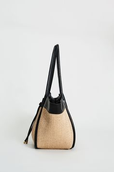 Step into Spring in style with our exclusive Raffia Tote Bag. Handcrafted in Italy, our chic, drawstring handbag is designed in the finest raffia fabric with contrasting Nappa Leather trim & gold handwear. With so many essentials to carry these days, this handbag puts the fashion in function with its knot Closure & ruched detailing. Elie Tahari Exclusive Raffia & Italian Leather Tote Bag with Gold Stud accents & a drawstring Knot Closure Measurements: 10" L, 20" Width, 12" Opening; Base 8"x6" Ma Luxury Woven Leather Straw Bag For Travel, Luxury Straw Bags For Everyday, High-end Straw Bags, Luxury Woven Leather Straw Bucket Bag, Luxury Straw Bucket Bag With Woven Leather, Luxury Straw Bucket Bag With Bamboo Handle, Luxury Straw Shoulder Bag For Travel, Luxury Shoulder Bag With Braided Handles In Straw, Luxury Travel Straw Bag