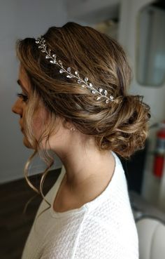 a woman wearing a bridal headpiece in her hair