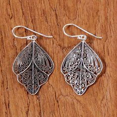 Elegant flowing shapes with spiral motifs share the appearance of closed butterfly wings in this pair of Thai dangle earrings. Learning from her mother and other Karen hill tribe silversmiths Lalana crafts the earrings from sterling silver filigree with a combination finish. Paw Print Jewelry, Ribbon Jewelry, Filigree Jewelry, Printed Jewelry, Filigree Earrings, Silver Dangle Earrings, Sterling Silver Filigree, Sterling Silver Dangle Earrings, Silver Buttons