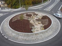 an aerial view of a circular road with rocks and gravel