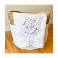 a basket with a monogrammed initial on it