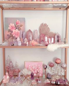 a shelf filled with lots of pink and white items