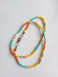 Colorful minimalist necklace is made of glass and plastic yellow / turquoise / orange seed beads. Brass jewelry components were used in making necklace. Stylish beaded necklace  is a perfect addition to summer outfits and it's a cute handmade gift for women and girls. You can combine it with other your necklaces. The length of the necklaces is  about 44 cm.  At the request the length of necklace can be changed.  All necklace brass findings are nickel-free. Please, pay attention to FAQs and if you have any question, don't hesitate to ask.  Thank you for visiting my shop! Yellow Round Bead Necklaces For Summer, Yellow Necklaces With Colorful Beads For Summer, Tiny Yellow Beads For Summer, Yellow Necklaces With Round Letter Beads, Yellow Round Beads Necklace For Summer, Yellow Beaded Necklaces With Letter Beads For Summer, Yellow Beaded Necklaces With Large Beads For Summer, Yellow Beaded Necklaces With Round Beads For Summer, Yellow Beaded Chain Necklaces For Summer