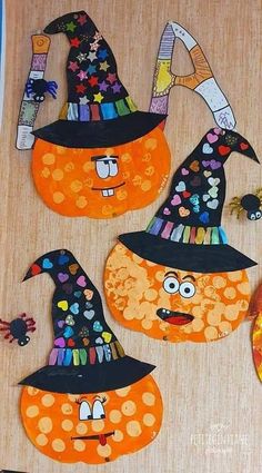 three paper pumpkins with witches on them