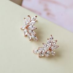 PETITE vintage style zircon  earrings  Great for you or for your bridesmaids. Colour: rose gold /clear Measurements: approx 18 x 12mm (small and delicate see pictures).  Materials:  rhodium components, zircon crystals. Stud earrings. Same style earrings in silver available here: https://www.etsy.com/uk/listing/620138849/set-of-3456-bridesmaid-earrings-bridal?ref=related-1 Great for wedding or other celebration. MORE SAME STYLE: https://www.etsy.com/uk/shop/BridalArtDeco?ref=listing-shop-header-item-count&section_id=23918122 Please note some images have been enlarged to allow for details to be shown. Read the descriptions for details on actual size of each item. In all my shop listings I have made every effort to ensure that the images match the item as closely as possible! However, colours Dazzling Cluster Earrings For Wedding, Vintage Gold Cluster Earrings For Wedding, Wedding Cluster Earrings With Sparkling Crystal Stones, Wedding Crystal Dangle Cluster Earrings, Vintage Nickel-free Crystal Earrings For Wedding, Crystal Teardrop Earrings, Zircon Earrings, Earrings Art, Art Deco Earrings