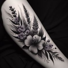 a woman's arm with flowers and leaves tattoo on the left side of her body