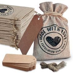 burlap bags with tags and twine on white background