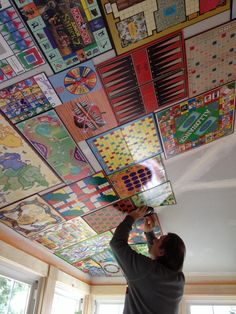 a man is working on a colorful ceiling