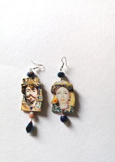 pair of earrings with woman's face on them