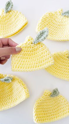 crocheted yellow hats with leaves on them