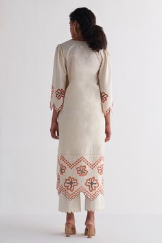 Ivory pure cotton woven kurta with floral, abstract and cutwork embroidered hemline and sleeves. Comes with pant.
Components: 2
Pattern: Embroidered
Type Of Work: Woven, Floral, Abstract, Cutwork
Neckline: Notched
Sleeve Type: Flared Sleeves
Fabric: Pure cotton
Color: Ivory
Other Details: 
Side slits and pockets on kurta
Occasion: Mehendi and Haldi - Aza Fashions Women Kurta, Straight Kurta, Floral Abstract, Cut Work, Pant Set, Color Ivory, Flared Sleeves, Aza Fashion, Cotton Weaving