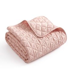 a pink quilted blanket folded on top of each other