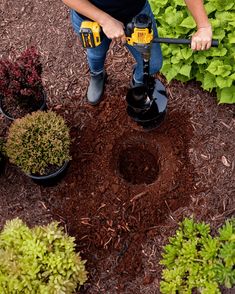 a man using a drill to fix a hole in the ground