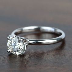 a close up of a diamond ring on a table