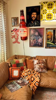 a living room filled with lots of furniture and pictures on the wall above it's couch