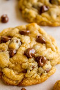 two chocolate chip cookies sitting on top of each other