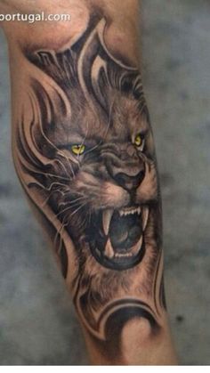 a man's leg with a lion tattoo on it and yellow eyes in the center