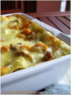 a casserole dish with meat, cheese and vegetables