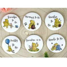 four buttons with winnie the pooh sayings on them