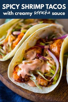 three chicken tacos with creamy srirac sauce on a wooden platter and text spicy shrimp tacos