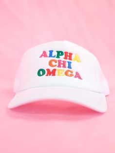 a white hat with the words alpha chi omega embroidered on it against a pink background