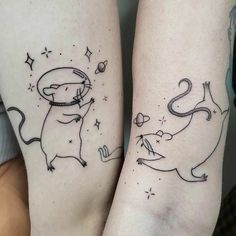 two people with tattoos on their legs and one has a cat in the other's hand