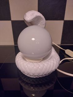 a white object sitting on top of a glass table