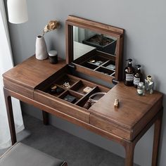 a wooden desk with a mirror and drawers on it