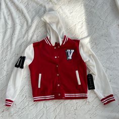 This Beautiful Red, And White Varsity Jacket With Extra Touches Is Perfect To Wear On Those Cold Days, It Adds A Super Good Extra Touch To Your Outfit Making It Even Better, It Is Also Very Comfortable And Easy To Wear. Size Medium. New With Tags. Only One In Stock, Get It Before It’s Gone!! White Hooded Varsity Jacket For Fall, White Hooded Varsity Outerwear, Red Sporty Varsity Jacket For Spring, Red Varsity Jacket For Spring, Trendy Red Varsity Jacket For College, Red Hooded Cotton Varsity Jacket, Red Hooded Varsity Jacket For Fall, Hooded Red Cotton Varsity Jacket, Red Varsity Jacket For Spring Streetwear