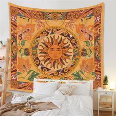 a sun tapestry hanging on the wall above a bed