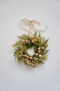 a christmas wreath hanging on a white wall