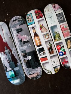 three skateboards with pictures on them are lined up next to each other in the shape of bookshelves