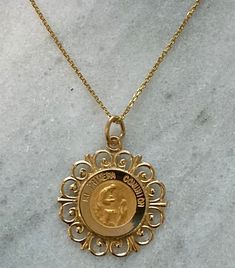 "Ornate Version , beautiful pendant Spanish \"Mi Primera Comunion\" 14K yellow gold, solid, written \"Mi Primera Comunion\" -In stock, ships within 1-2 business days -solid 14k yellow gold, not plated or gold filled. -approximately 3/4 Inch in diameter -Perfect for special gift for first commuion -ideal for both gender Communion -ideal for a special gift -ideal size to be medium sized style charm -14K yellow gold (photograph in 14K yellow gold) Chain A: Dainty cable style chain in 14K yellow gol Gold Large Pendant Jewelry For Commemoration, Engraved Yellow Gold Necklaces For Celebration, Engraved Yellow Gold Jewelry For Celebration, Commemorative Gold Jewelry With Large Pendant, Yellow Gold Engraved Necklaces For Celebration, Engraved Yellow Gold Necklace For Celebration, Hallmarked 14k Gold Jewelry For Celebration, Engraved Yellow Gold Jewelry For Commemoration, Celebration Hallmarked 14k Gold Jewelry