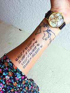 a person with a wrist tattoo has a watch on their left arm and is wearing a flower print dress