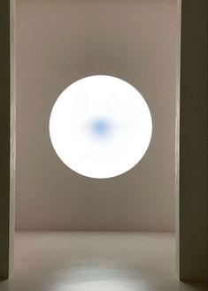 an empty room with a round light in the center