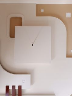 an overhead view of a clock in the middle of a room with white walls and brown trim